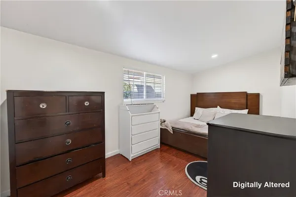 a bedroom with a bed and a dresser