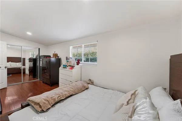 a bed room with a bed and a television