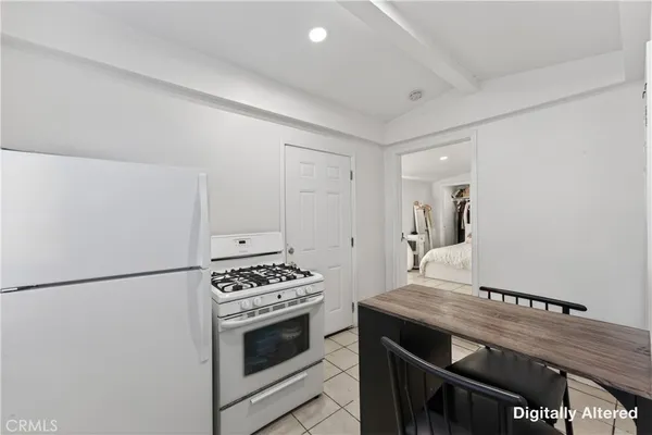 a kitchen with cabinets and steel appliances