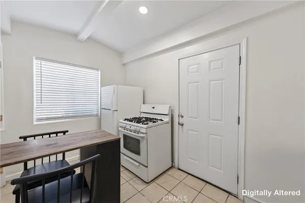 a kitchen with a stove and a refrigerator