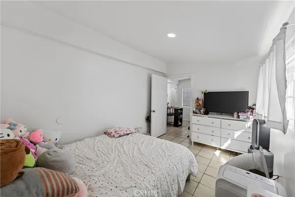 a bedroom with a bed and flat screen tv