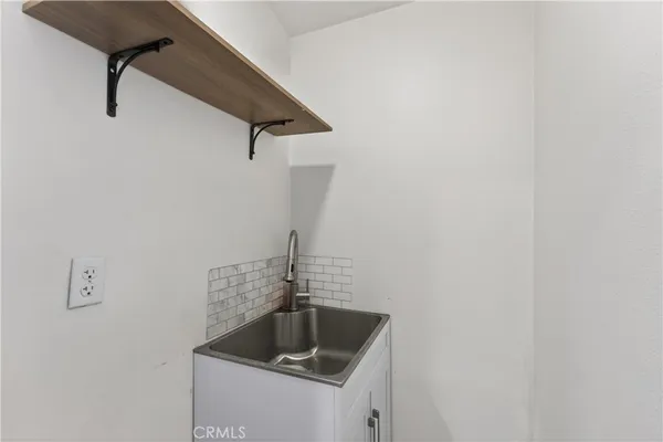 a view of walk in closet with clothes