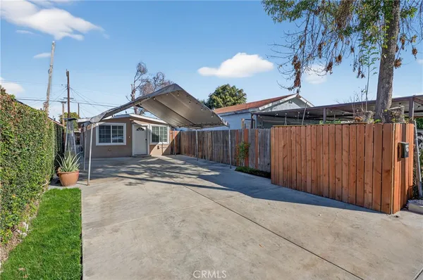a view of a house with wooden fence