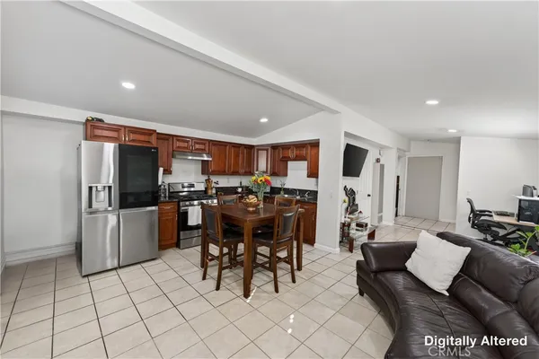 a living room with furniture and a dining table with kitchen view
