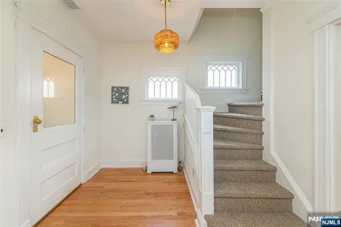 a view of an entryway with wooden floor and a front door