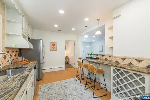a view of a kitchen with granite countertop a sink and a counter top space