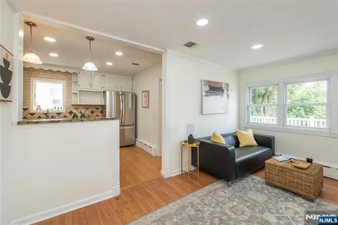 a living room with furniture and a kitchen
