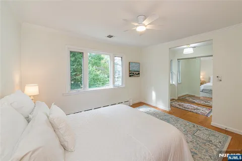 a bedroom with a large bed and a chandelier