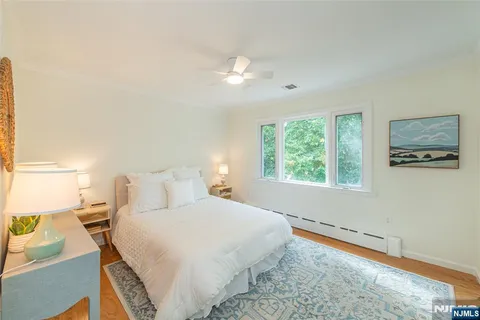 a bedroom with a bed and a large window