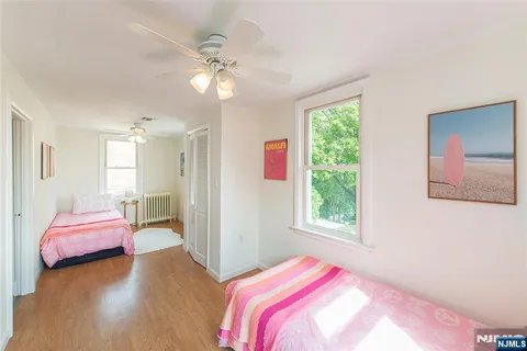 a bedroom with a bed chandelier and a window