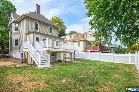 a view of a house with a backyard