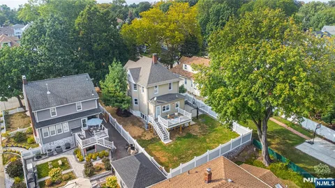 an aerial view of residential house with outdoor space and trees