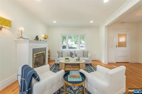 a living room with furniture a fireplace and a table
