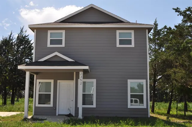 a front view of a house with a yard