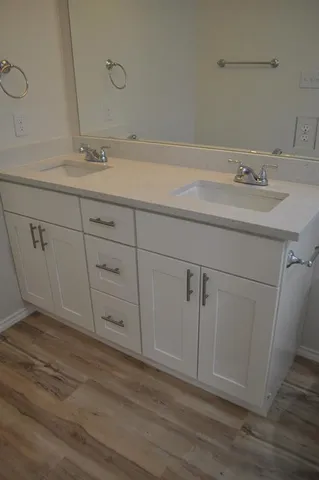 a bathroom with a sink and cabinets