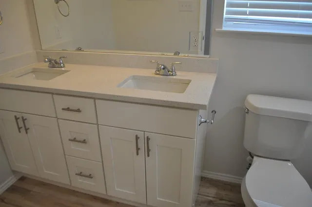 a bathroom with a sink toilet vanity and tub