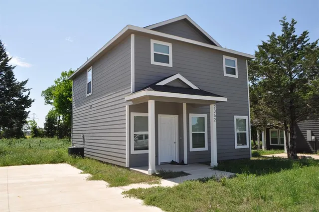 a front view of a house with a yard