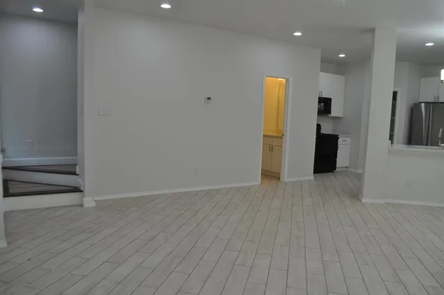 a view of a kitchen from the hallway with a sink