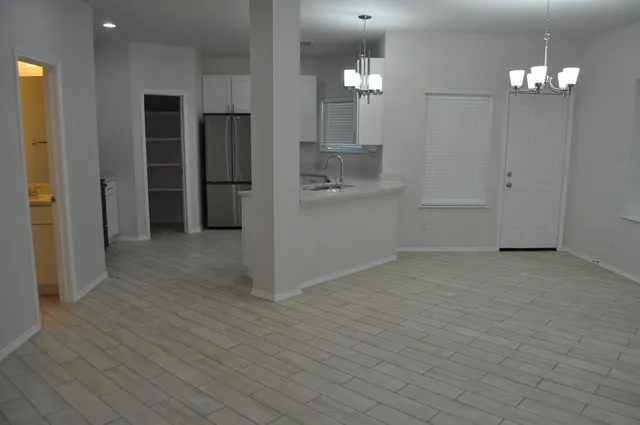 an empty room with wooden floor and closet