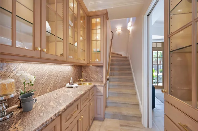 a kitchen with a stove a sink and cabinets