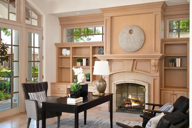 a kitchen with stainless steel appliances granite countertop a stove top oven a sink dishwasher a dining table and chairs with wooden floor