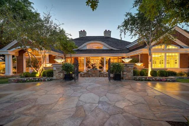 a view of a house with a yard and a pond