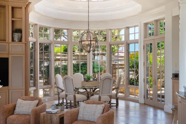 a view of a bedroom with furniture and large window