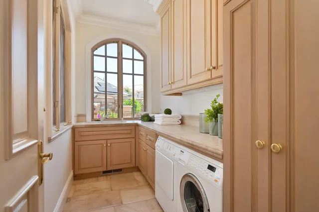 a living room with lots of white furniture and a large window