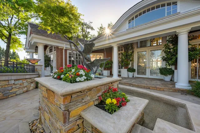 a living room with furniture a fireplace and a large window