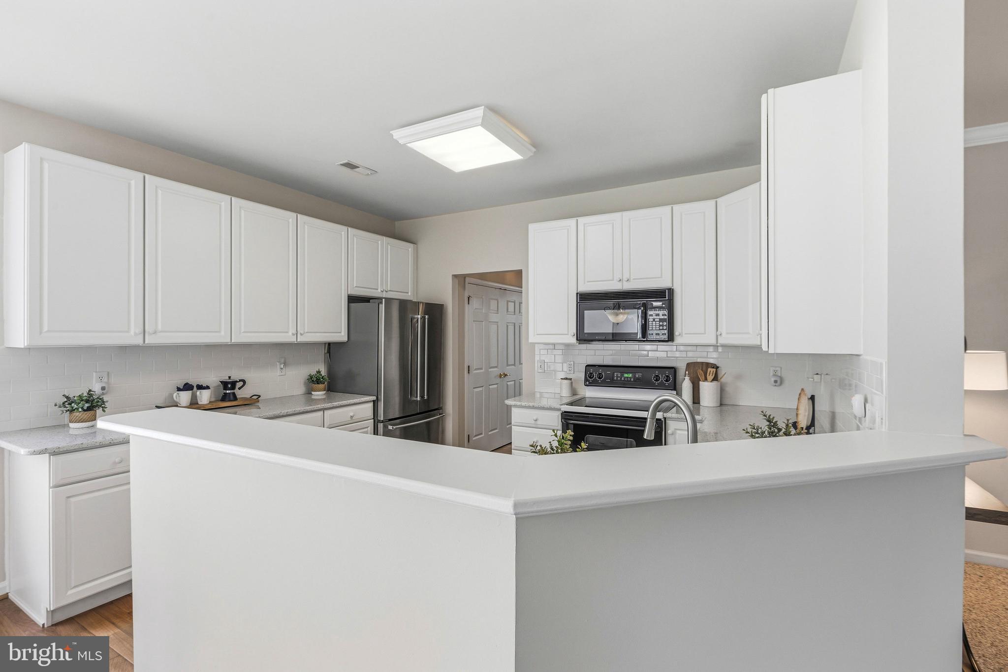 88 Springmill Drive Middletown, DE 19709 - Photo 13 of 63 a kitchen with stainless steel appliances a refrigerator sink stove and microwave