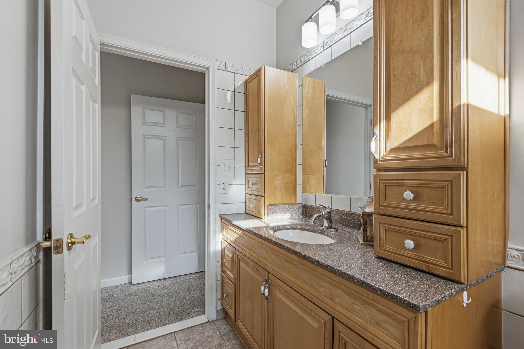 88 Springmill Drive Middletown, DE 19709 - Photo 22 of 63 a bathroom with a granite countertop sink and a mirror