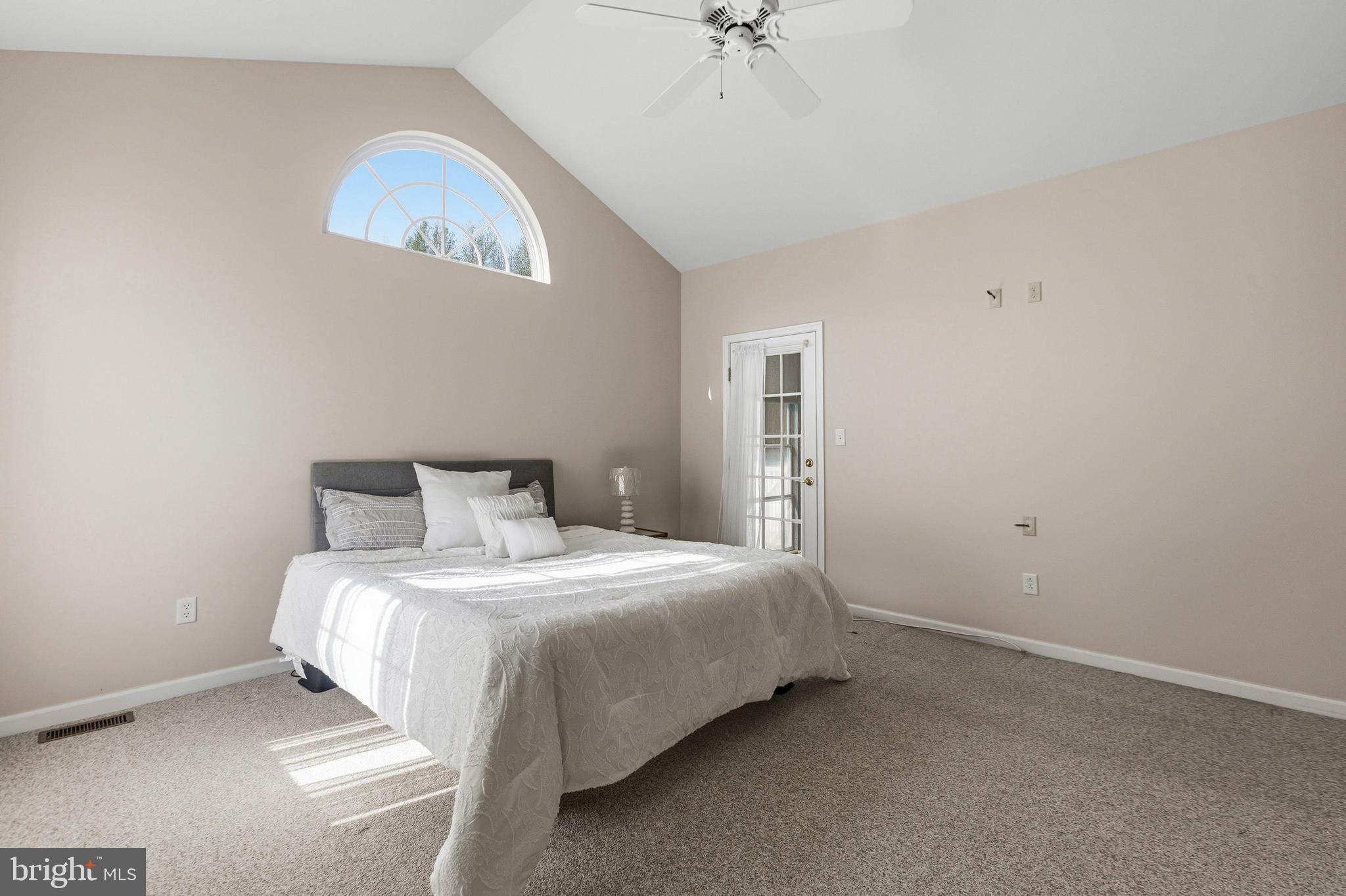 88 Springmill Drive Middletown, DE 19709 - Photo 27 of 63 a bedroom with a bed and a chandelier