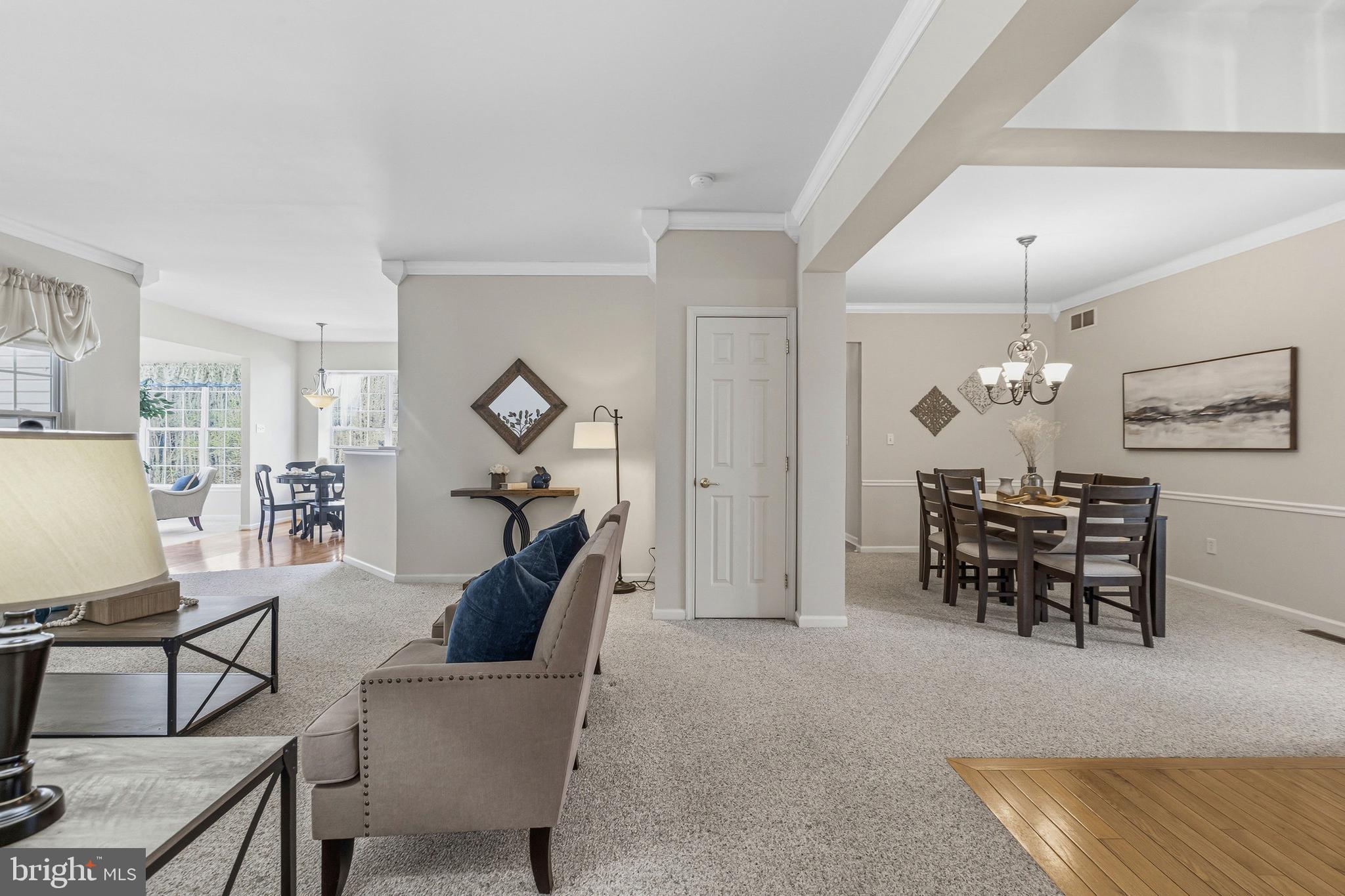 88 Springmill Drive Middletown, DE 19709 - Photo 28 of 63 a living room with furniture a dining table and a chandelier