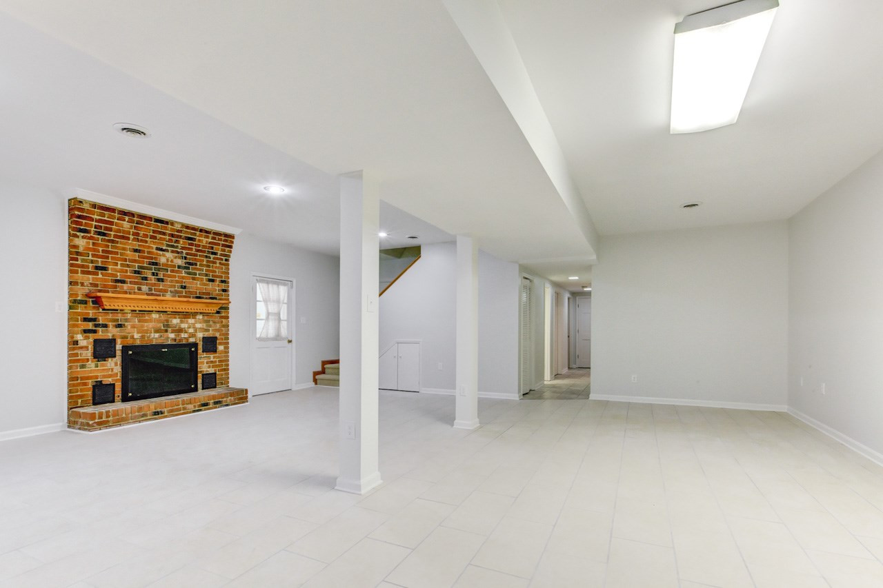 5009 Will-O-Dean Road Raleigh, NC 27616 - Photo 18 of 25 Lower Level Den with Brick Fireplace