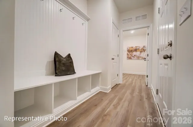 a view of a room with wooden floor