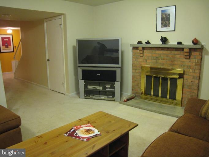 7424 Timberock Road Falls Church, VA 22043 - Photo 28 of 30 Wood burning fireplace with brick hearth