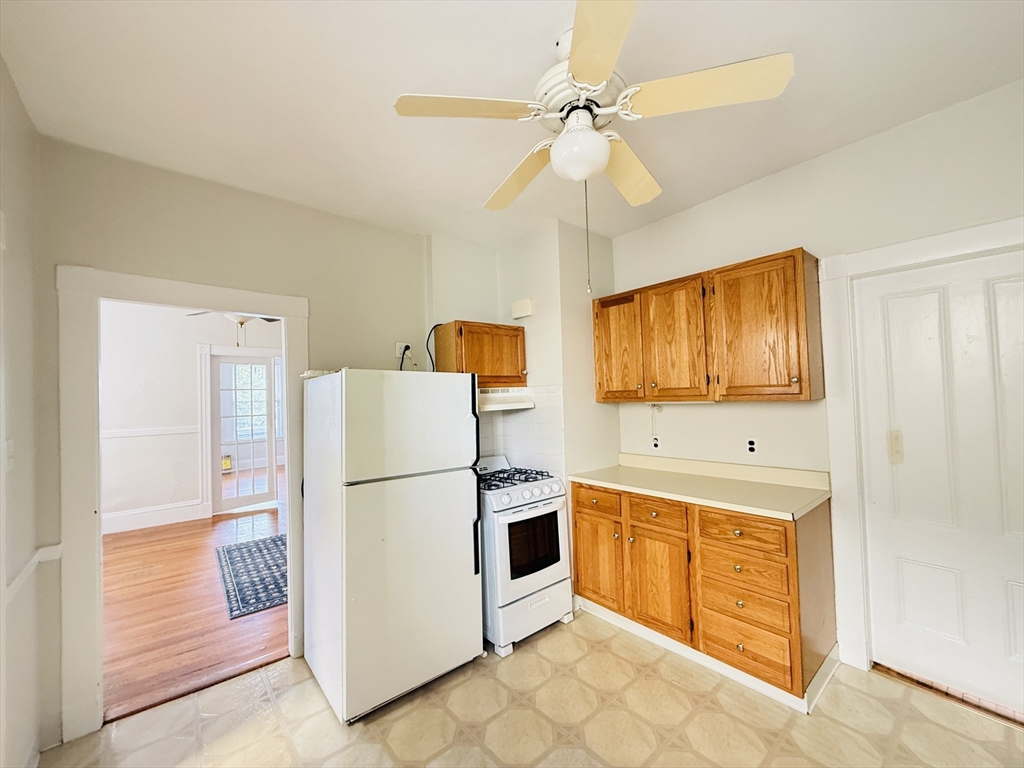 35 Kingston Street, Unit 1 Somerville, MA 02144 - Photo 2 of 8 a kitchen with stainless steel appliances a refrigerator and a stove top oven