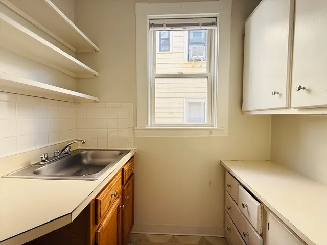 a kitchen with a sink and cabinets