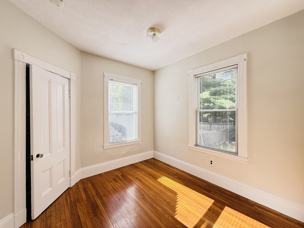 35 Kingston Street, Unit 1 Somerville, MA 02144 - Photo 6 of 8 a view of empty room with wooden floor and fan