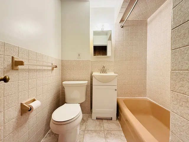 a bathroom with a toilet a sink and bathtub