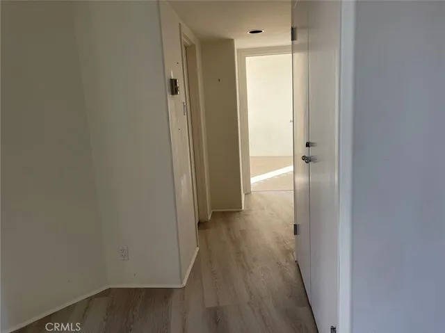 a view of a room with wooden floor