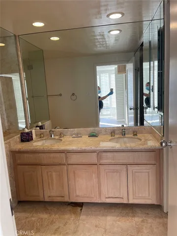 a bathroom with a double vanity sink and mirror
