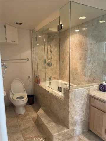 a bathroom with a toilet sink and shower