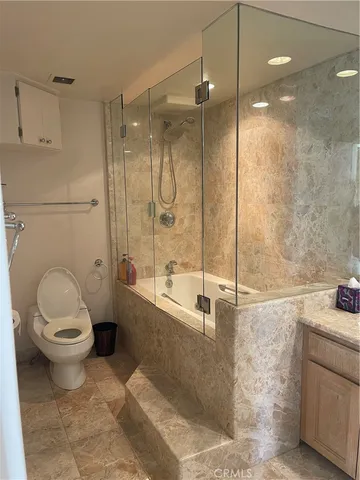 a bathroom with a toilet sink and shower