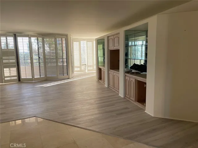 a view of a living room with wooden floor and furniture