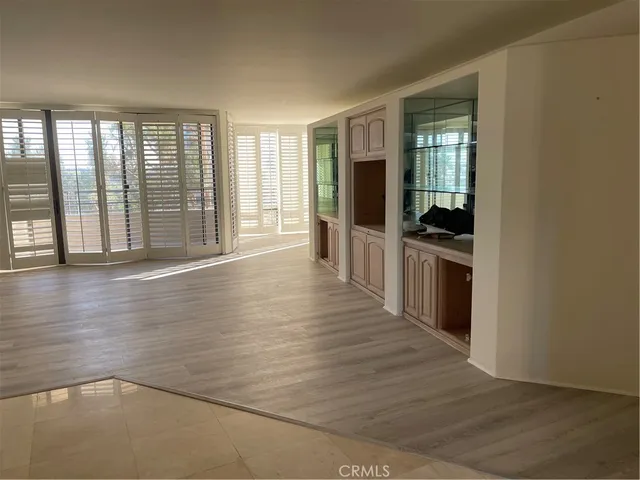 a view of a living room with wooden floor and furniture