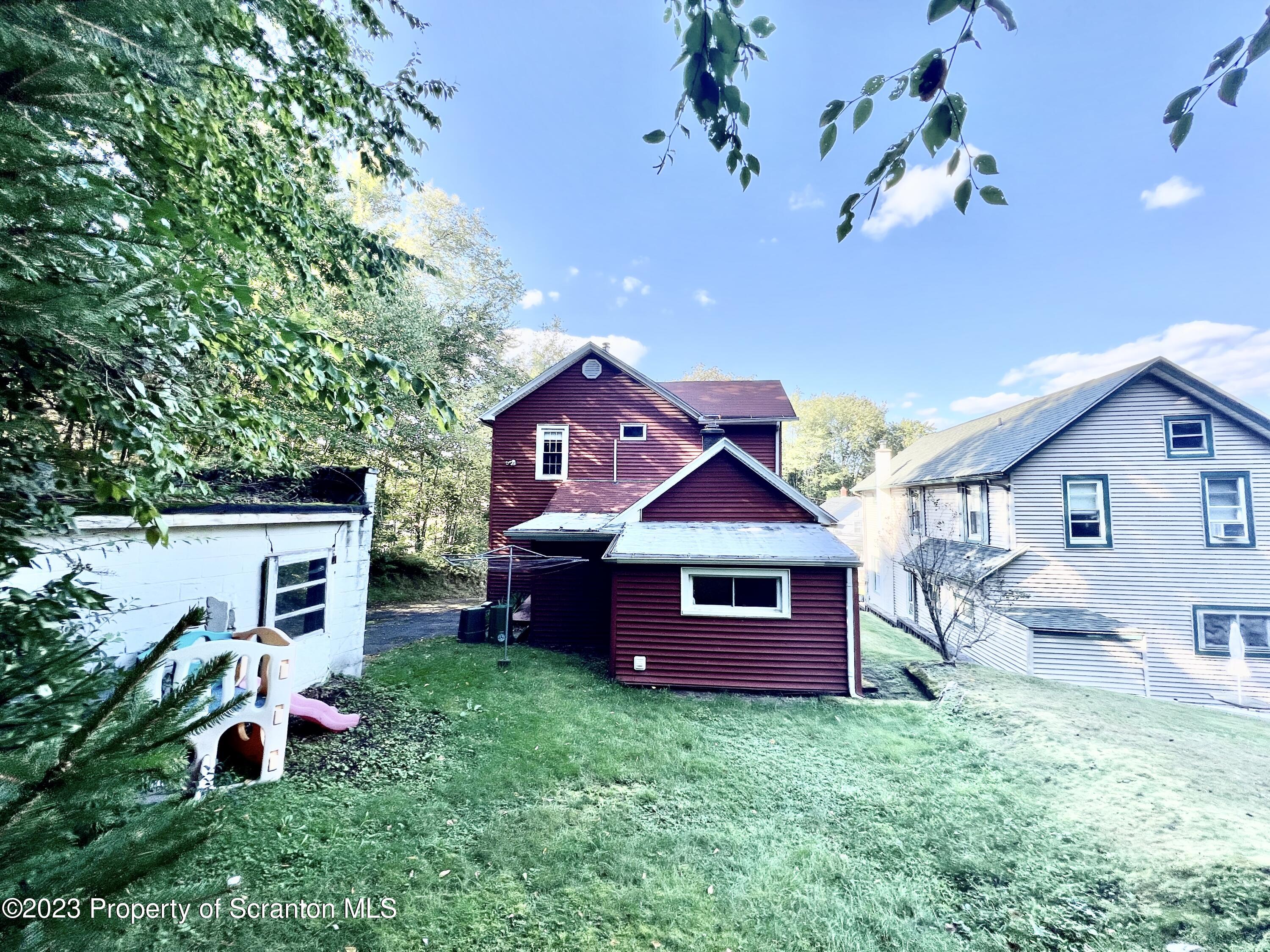959 Constitution Avenue Jessup, PA 18434 - Photo 26 of 27 a front view of a house with a garden