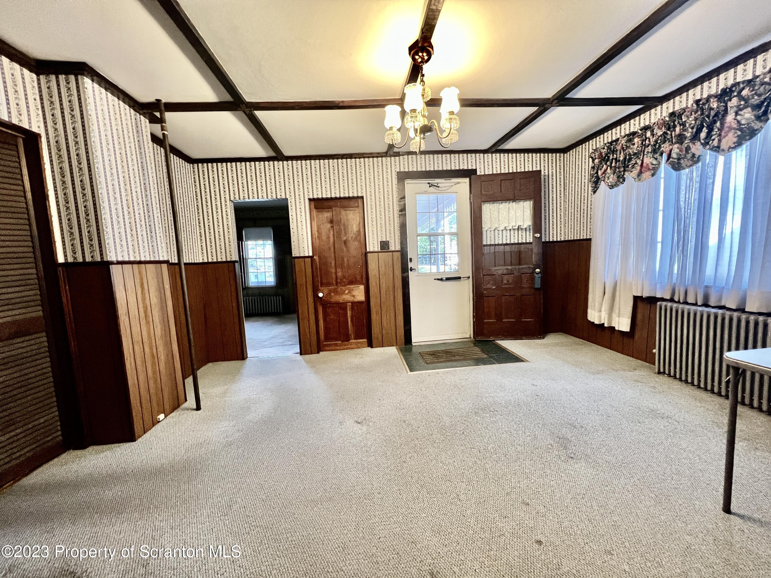 959 Constitution Avenue Jessup, PA 18434 - Photo 4 of 27 a view of a hallway with wooden walls
