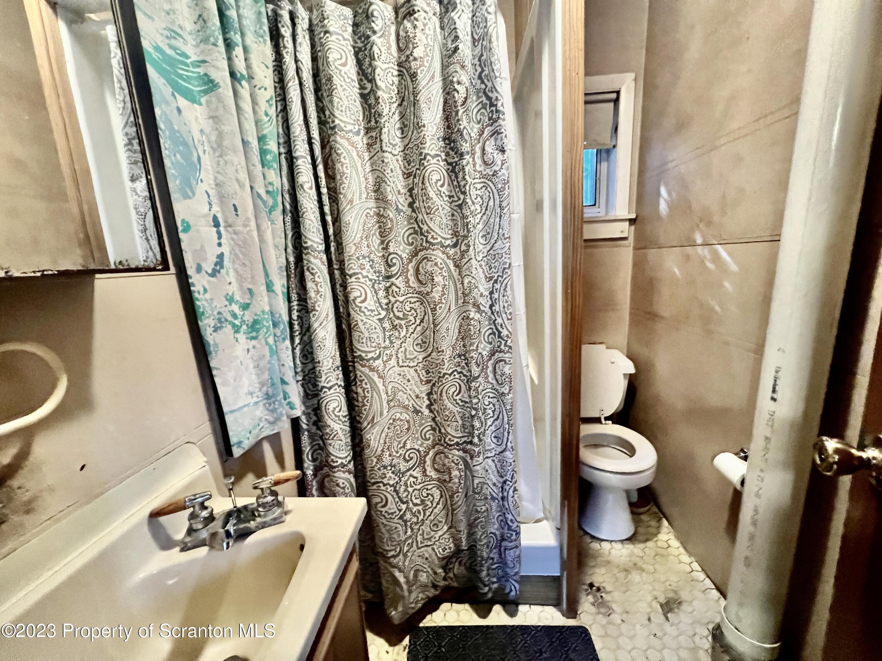 959 Constitution Avenue Jessup, PA 18434 - Photo 9 of 27 a bathroom with a sink a toilet and a mirror