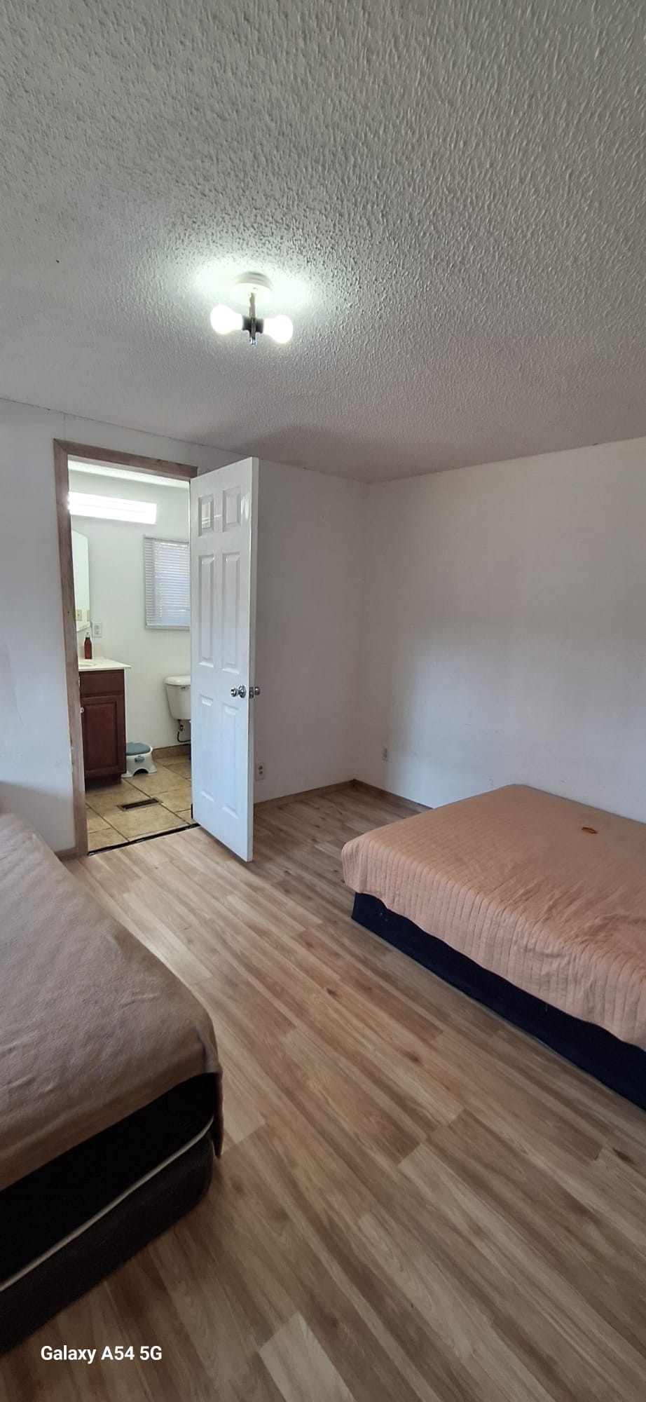 342 East Little Richland Road Waverly, TN 37185 - Photo 5 of 17 a bedroom with a bed and a night stand